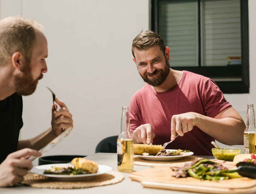 Sticks and Stones Outdoor Tim + Kyle enjoying food cooked on the Kadai Fire Pit 